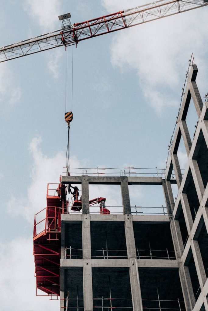 Crafting Captivating Headlines: Your awesome post title goes here From below of unrecognizable male foremen standing on half built building during work at construction site against cloudy blue sky